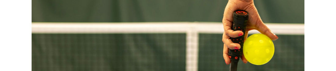 A person holding Pickleball Ball and Paddle